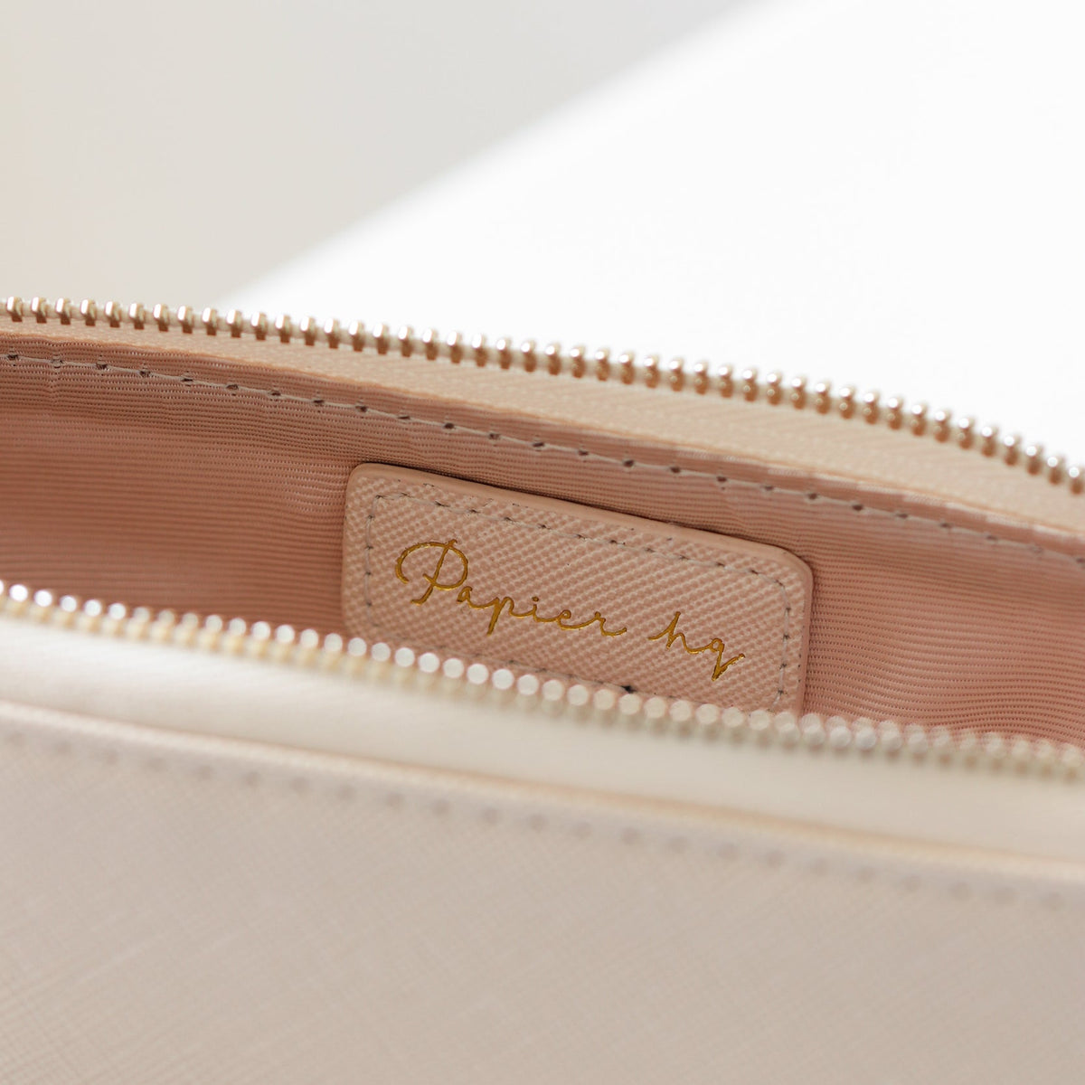 Inside of the pink pouch showing the lining and embossed Papier HQ logo