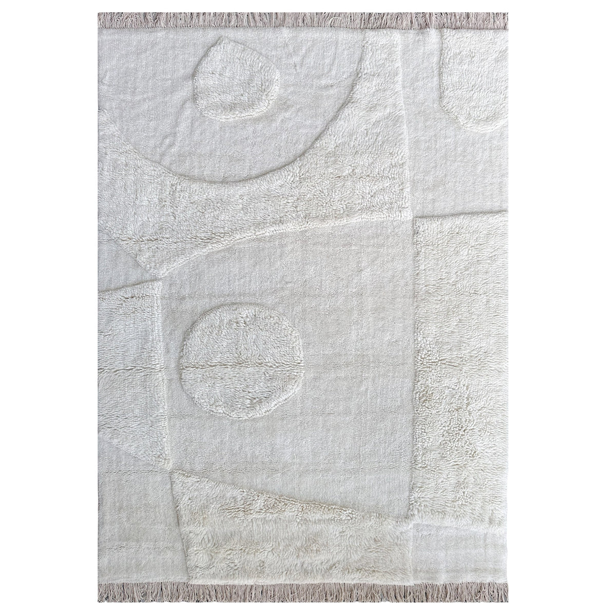 Ermitano Rug in ivory wool with carved circles in a high-low pile and fringed ends, shown flat