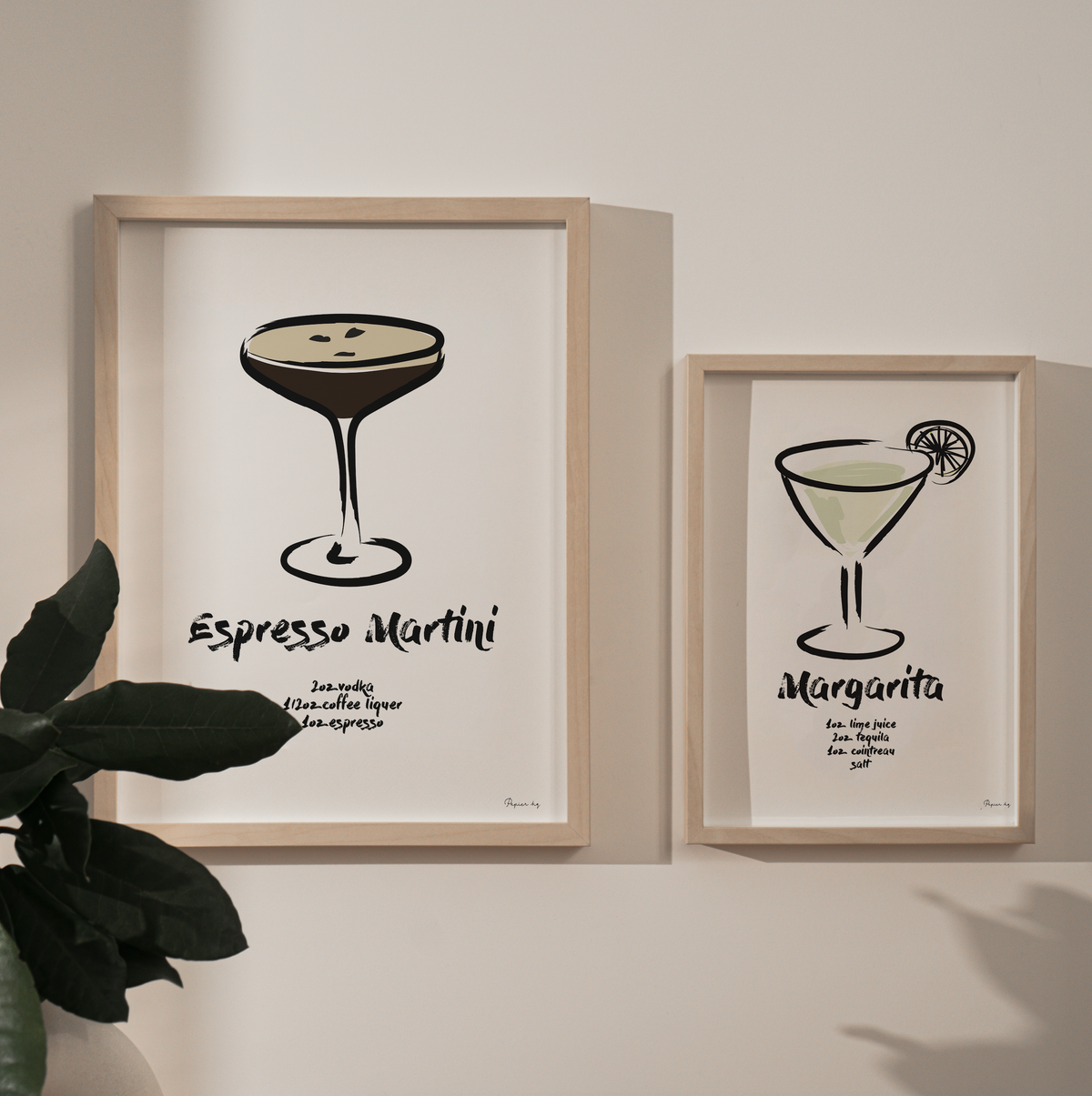 Espresso Martini print in a natural frame beside a smaller Margarita print on a soft grey wall
