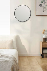 A versatile bedroom with a Bella Round Wall Mirror - 60 cm - Black / Brass / Chrome from Flux Home above a bed.