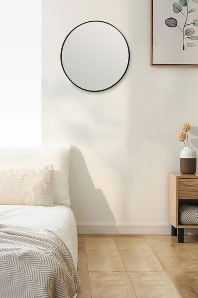 A versatile bedroom with a Bella Round Wall Mirror - 60 cm - Black / Brass / Chrome from Flux Home above a bed.