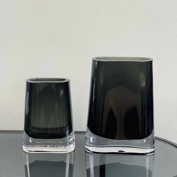 Two Lars Glass Vases by Flux Home on a table, adding a touch of elegance to the décor.