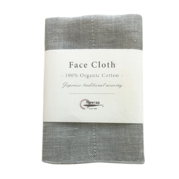 Nawrap binchotan face cloth in charcoal grey, folded in its paper band, on white