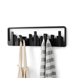 An Umbra Skyline Wall Mounted Hook coat rack with hooks for small spaces.