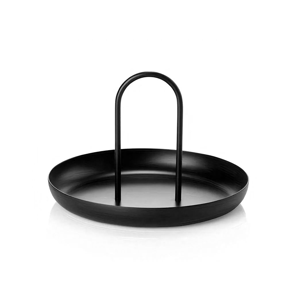 Black FIKA round tray photographed at an angle, showing the shallow dish and looped handle
