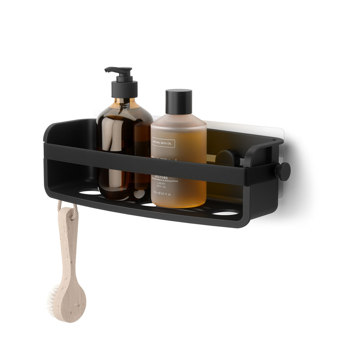 Umbra Flex adhesive shower bin in black holding bath bottles, a brush hanging below