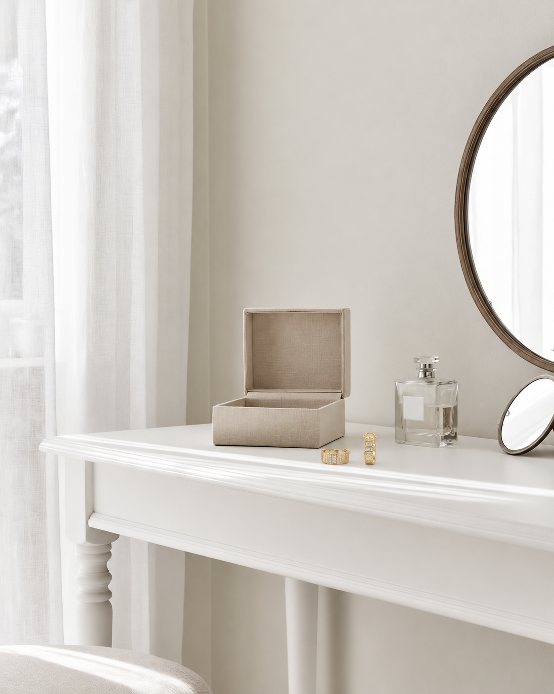 Federation Impressions Earrings in gold with clear crystals on a white dressing table beside an open jewellery box