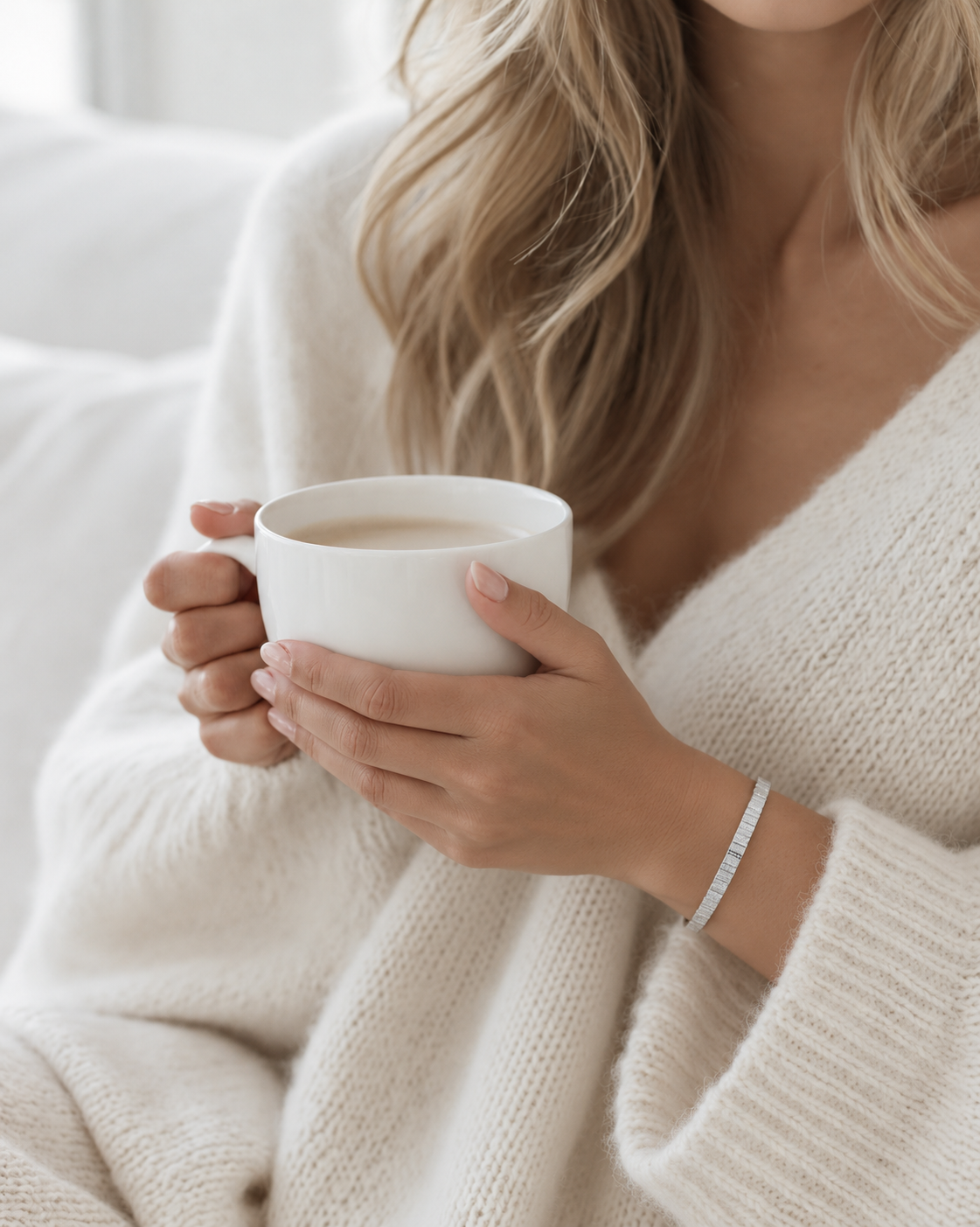 Woman holding a coffee cup wearing the Federation Impressions Bracelet in matte silver