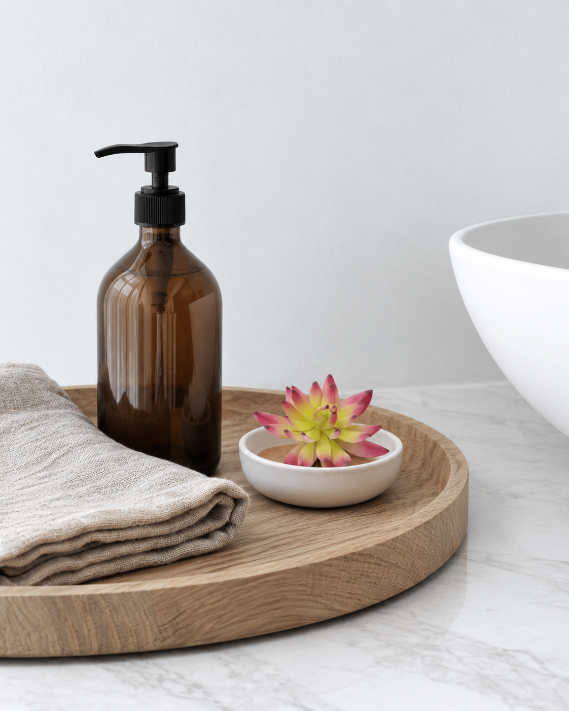 Cerise albiflora sedum pick in a small white ceramic dish on a tray beside a basin