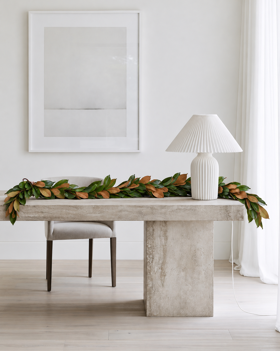 Magnolia leaf garland laid along the back of a desk console with ends trailing over the sides