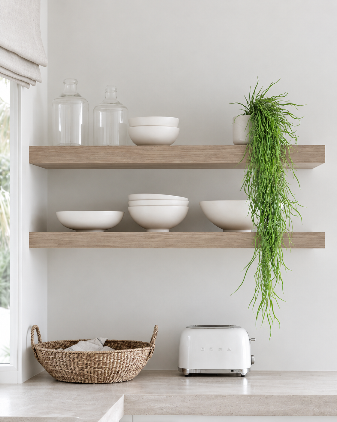Hanging grass vine trailing from a small white pot on a timber kitchen shelf