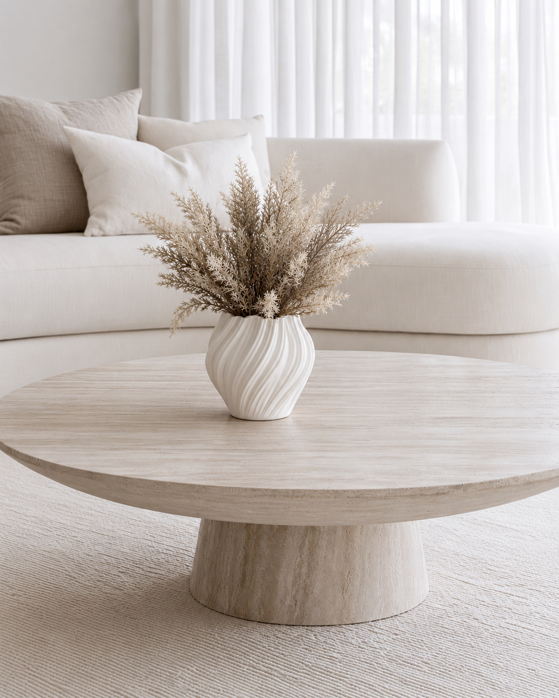 Astilbe Bundle in Mocha in a small white ceramic vase on the round coffee table