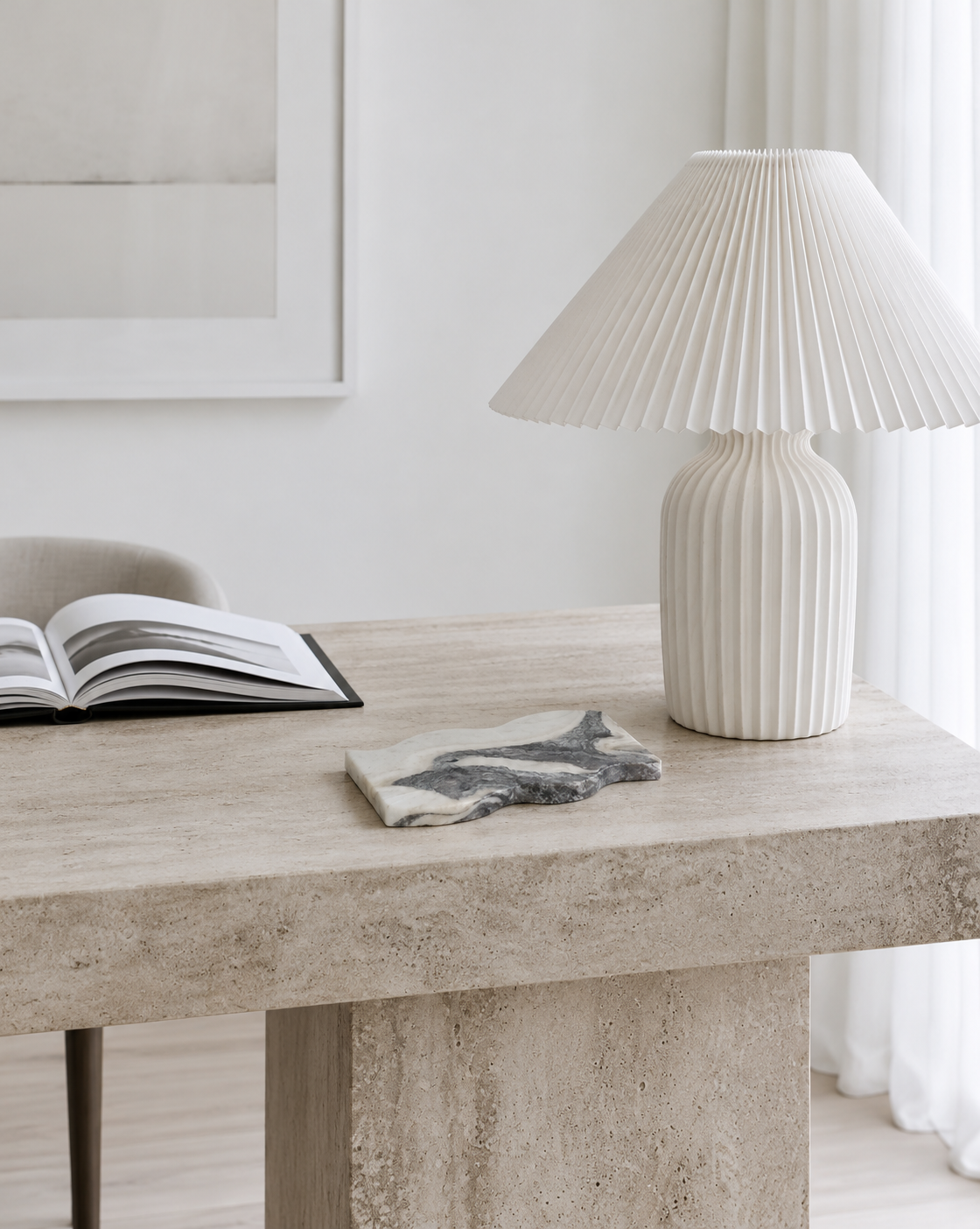 Frida Wavy Marble Tray on the travertine desk beside the lamp