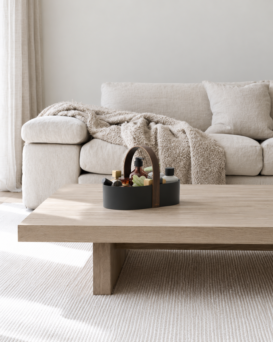 Bellwood Caddy by Umbra, Storage Organiser with Handle in Black/Walnut styled on a coffee table