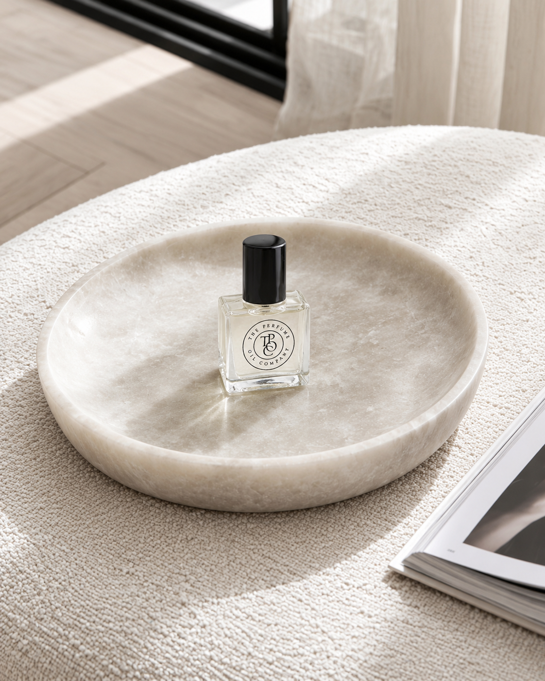 MYTH Perfume Oil on a round tray on the ottoman