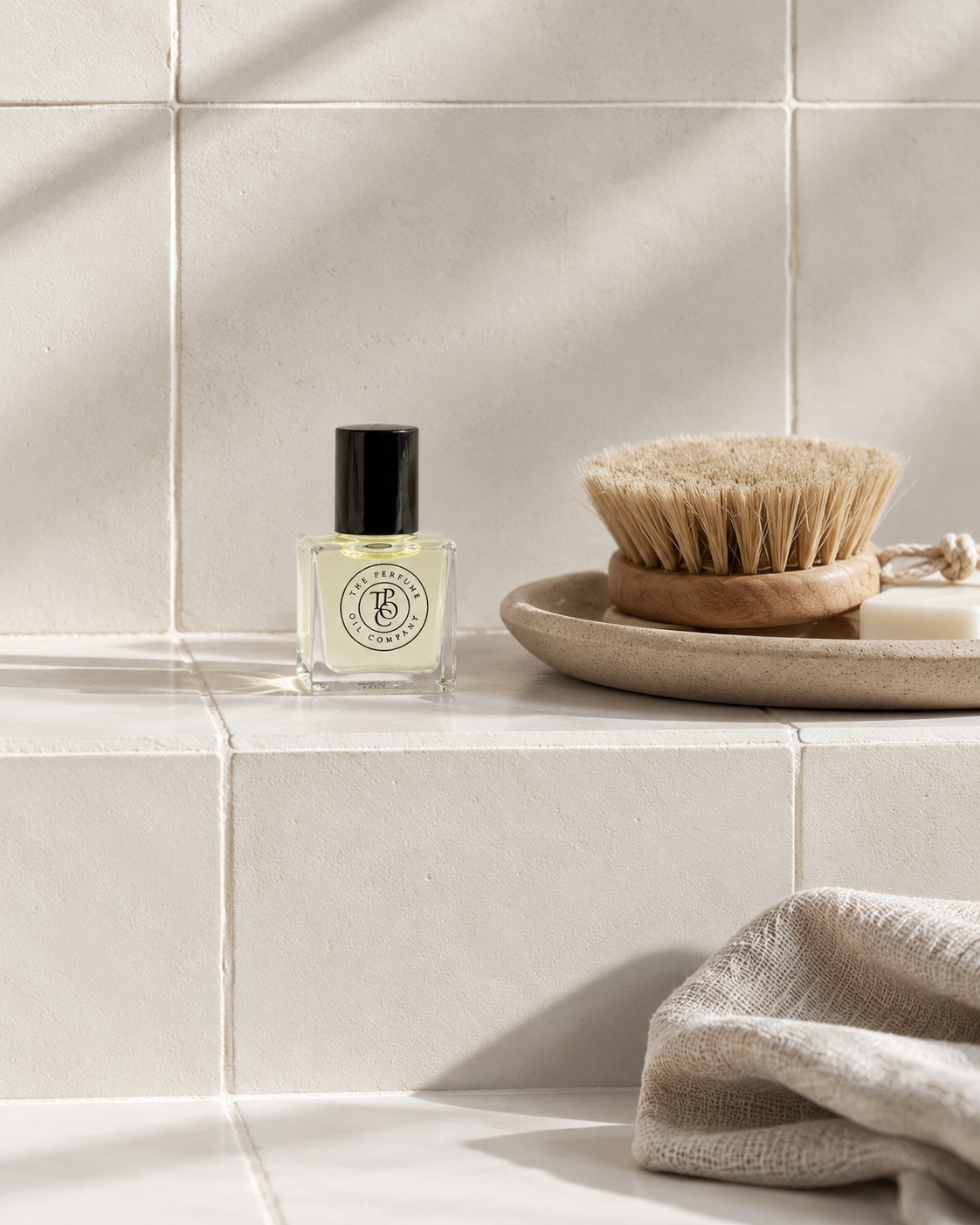 SUAVE Perfume Oil on a stone wall ledge
