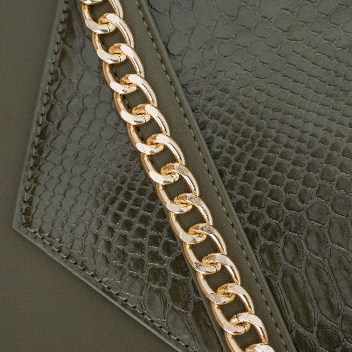 Close-up of the gold chain detail on the Forest Green croc-texture sleeve