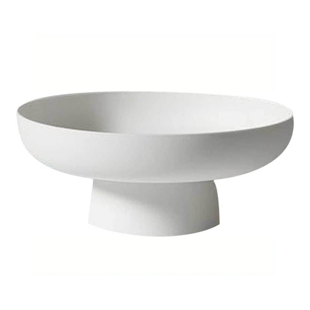 Matte white pedestal bowl, a wide shallow bowl on a tapered foot, seen from the side on white