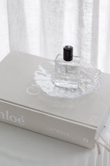 Glacier bubble glass tray with perfume bottle styled on Chloé Catwalk coffee table book in soft white sheer curtain setting