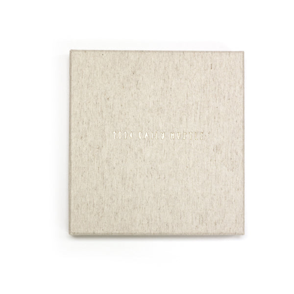 A 2024 Daily Hustle Planner in Oatmeal with a Write To Me cover on a white background.