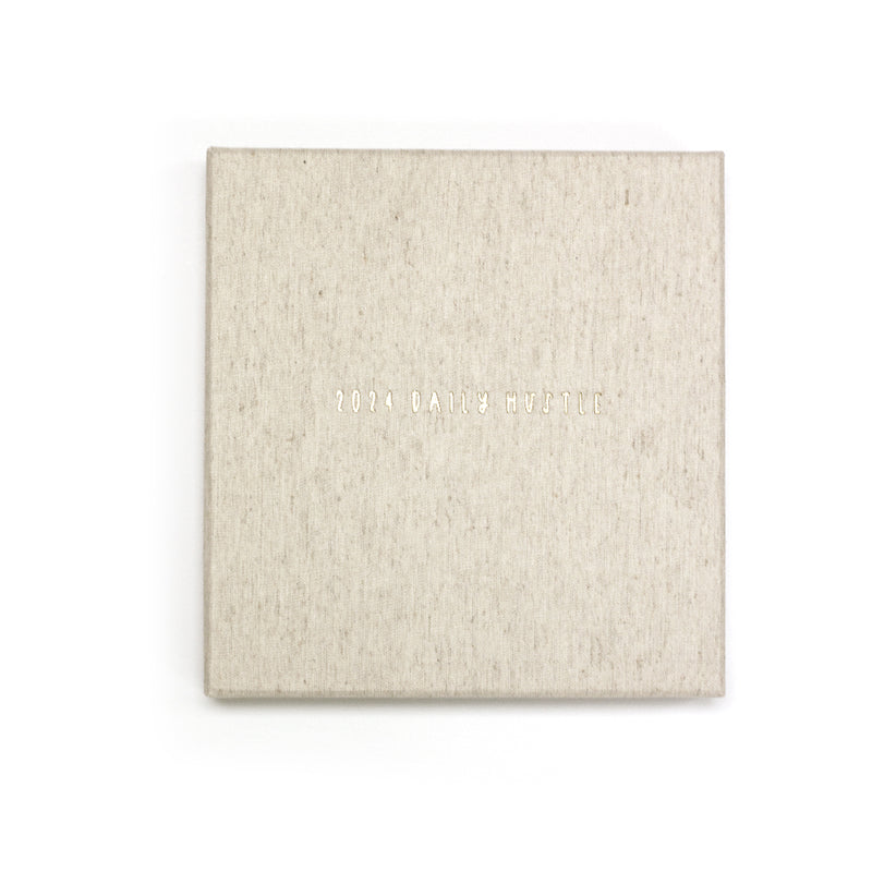 A 2024 Daily Hustle Planner in Oatmeal with a Write To Me cover on a white background.