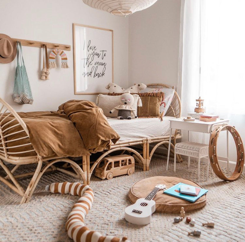 I Love You To The Moon print in a child's bedroom with rattan furniture and toys