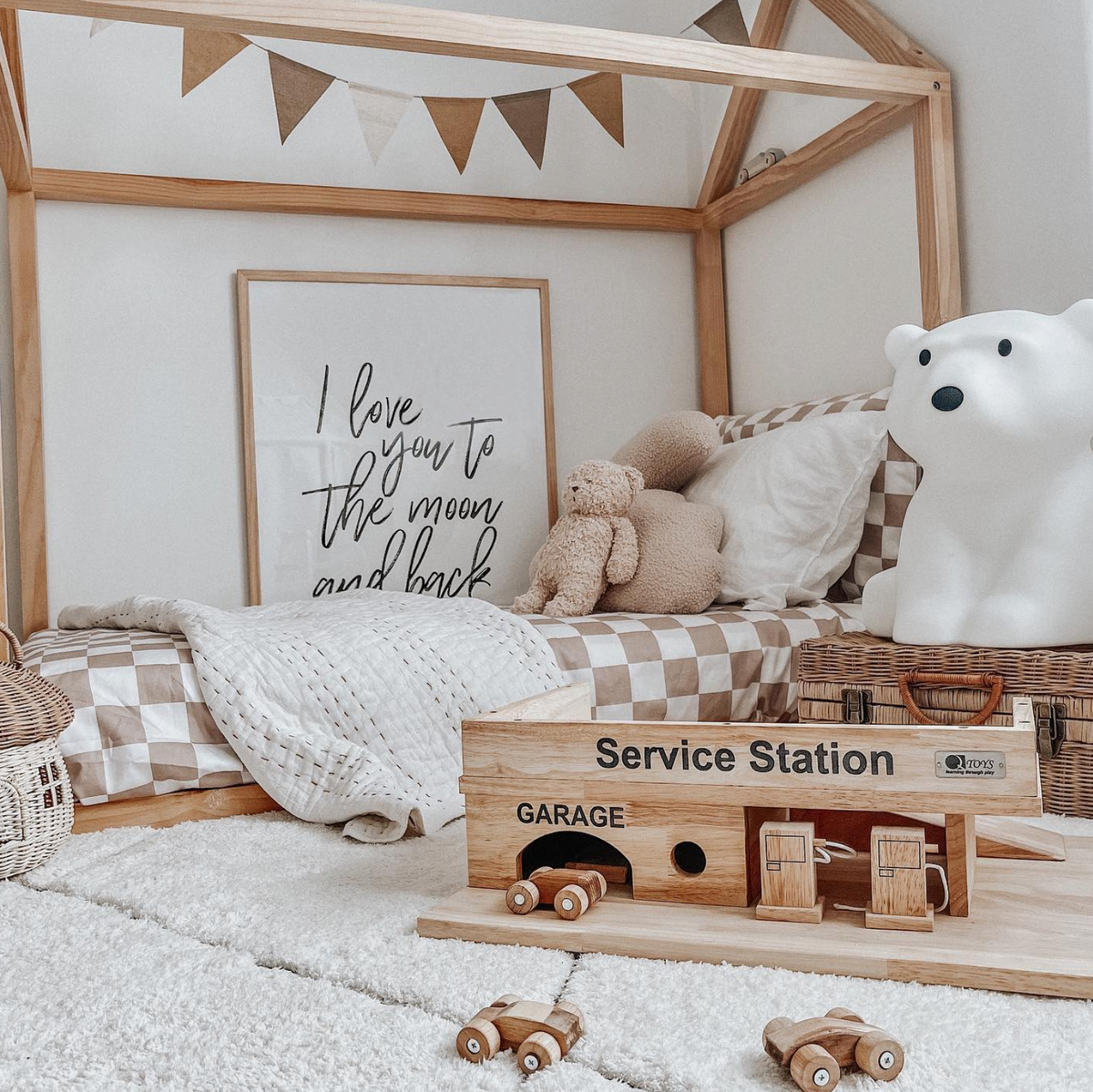 I Love You To The Moon print in a natural frame in a child's room with toys and a polar bear lamp