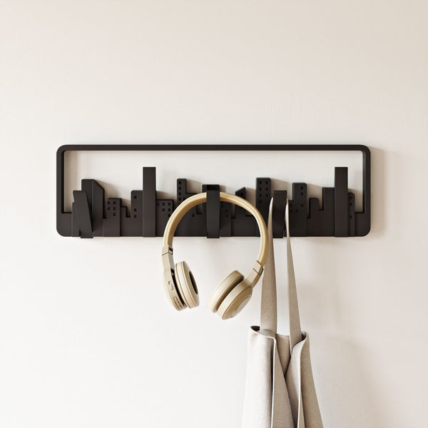 An Umbra Skyline Wall Mounted Hook with headphones designed as a small spaces wall art.