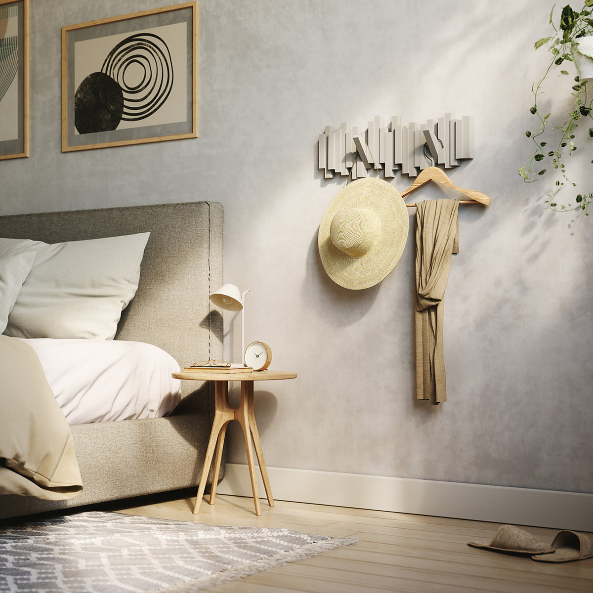 Umbra Sticks 5 hook rack in grey on a bedroom wall holding a hat and a robe