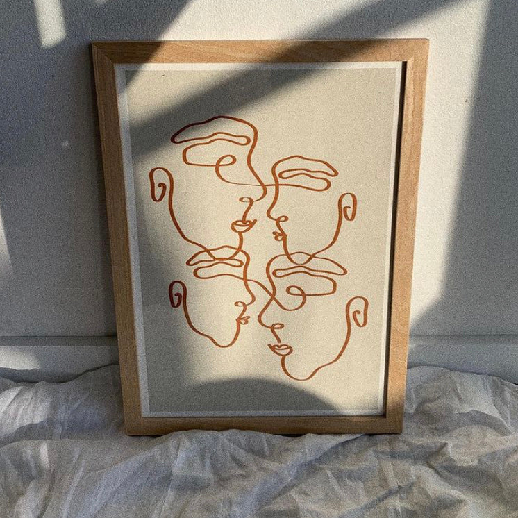 Imperfectly Perfect natural print in a natural frame resting on white linen in soft sunlight