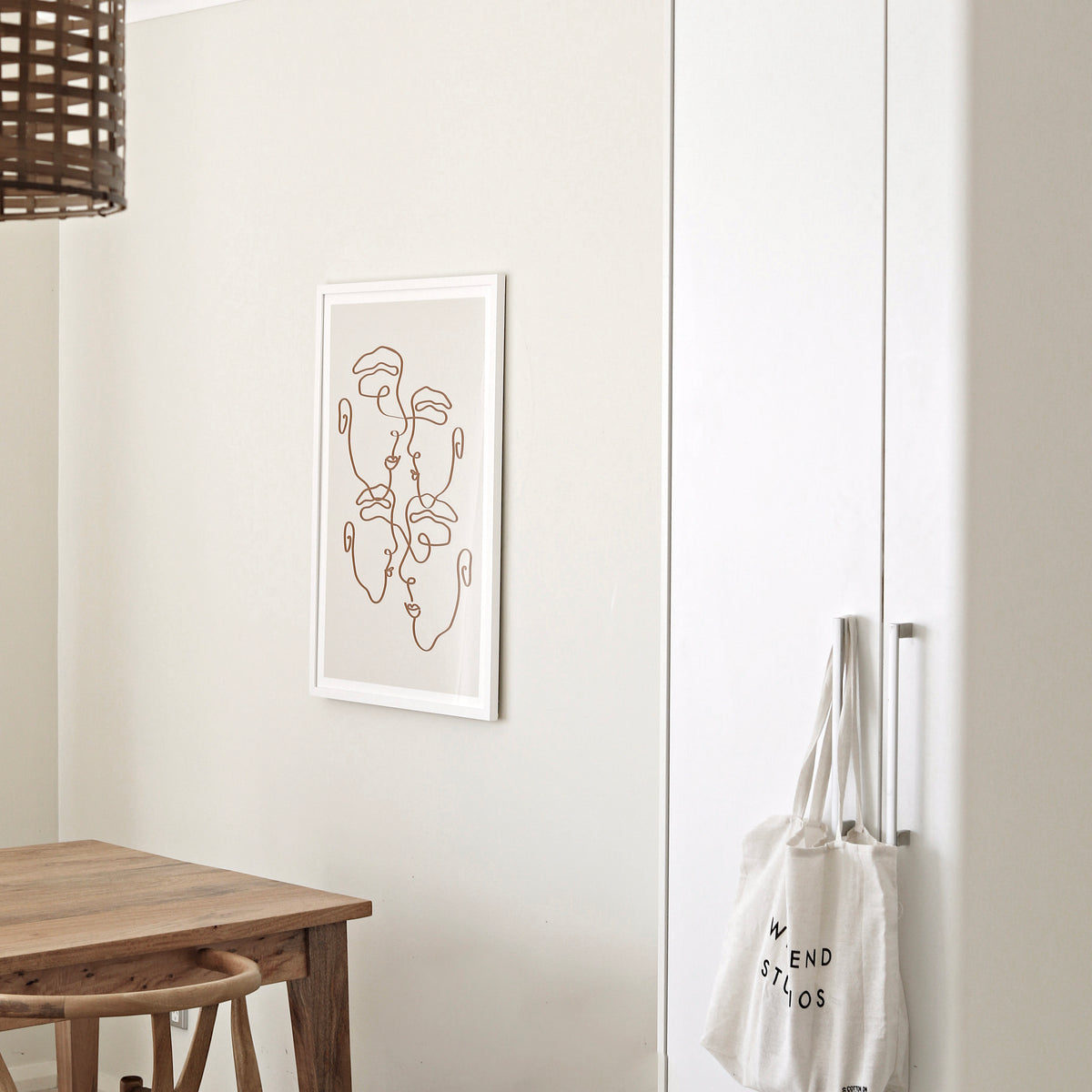 Imperfectly Perfect natural print in a white frame on a cream wall beside a timber table