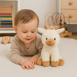 Toddler playing with Juno the Giraffe soft toy by Lily & George in a softly styled nursery
