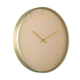 Beige wall clock with gold rim and hands on a white background