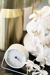 Karlsson Stark Alarm Clock in white with minimalist dial and silent movement, styled on bedside with lamp and flowers.