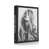 A black and white photo of a woman with long hair featuring KATE: THE KATE MOSS BOOK by Books.