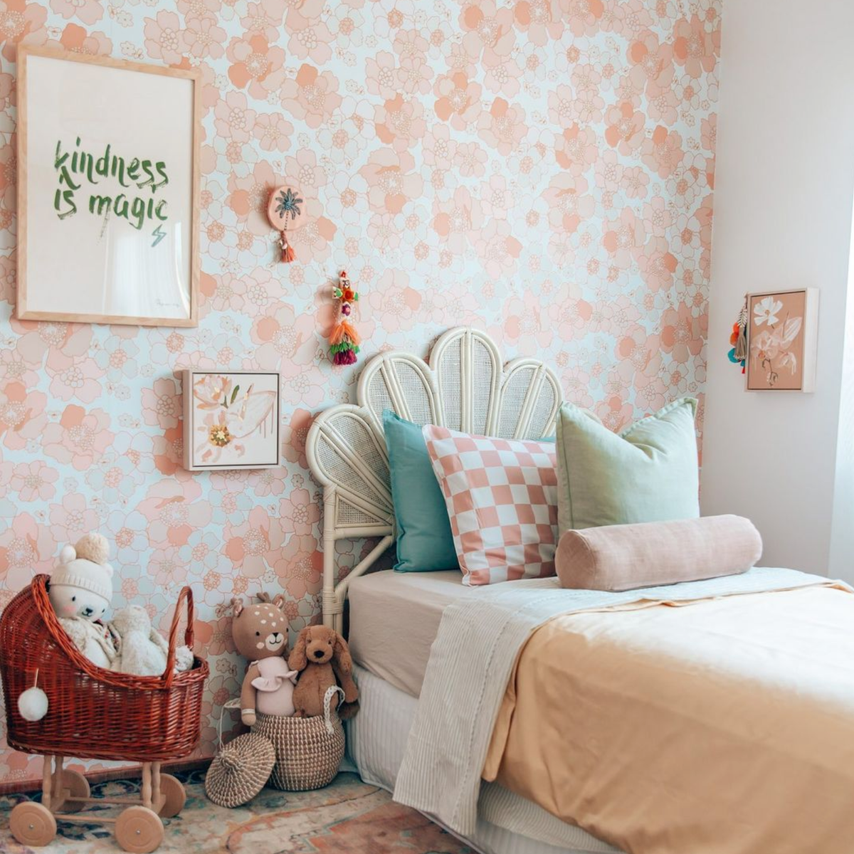Kindness Is Magic print in khaki framed on a floral papered wall in a girl's bedroom