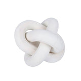 A white Flux Home wooden knot ornament on a white background.