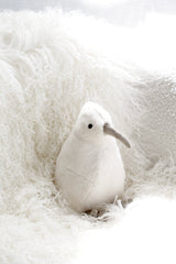 White kiwi soft toy by Lily & George styled on fluffy white throw