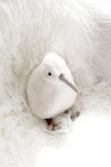 Koko the Kiwi soft toy in white styled in a softly styled nursery setting
