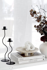 Large faux eucalyptus spray in deep brown, styled in white vase with books and candles; realistic 86cm artificial stem.