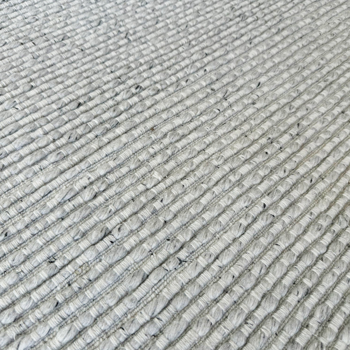 Close view of the raised light grey ribs in the wool blend weave