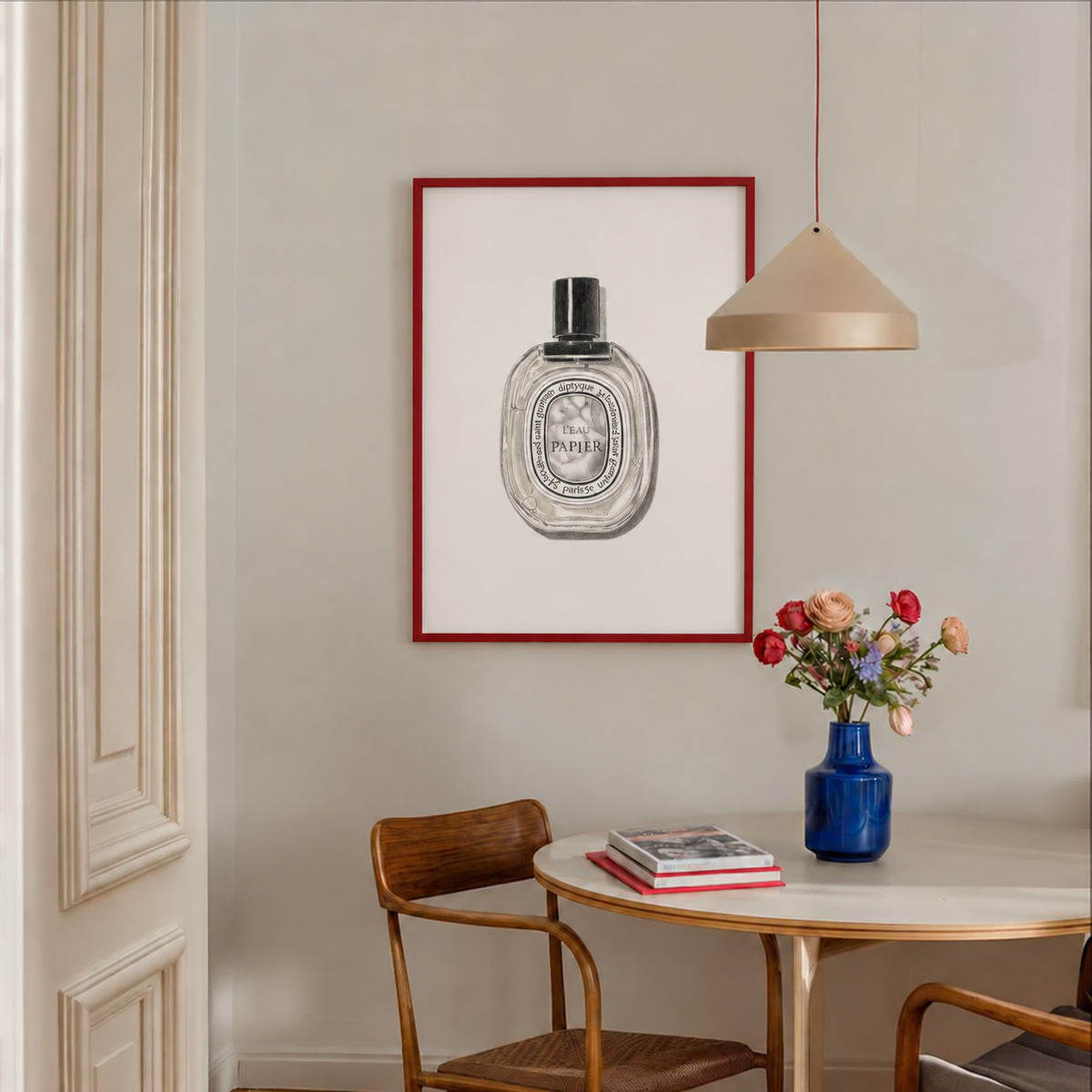 L'eau Papier perfume bottle sketch by Papier HQ in a red frame, styled at home