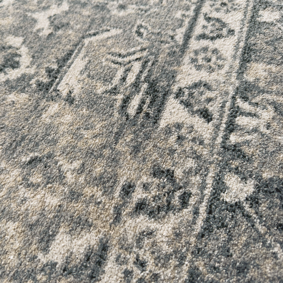 Close view of the faded floral border in slate grey and cream