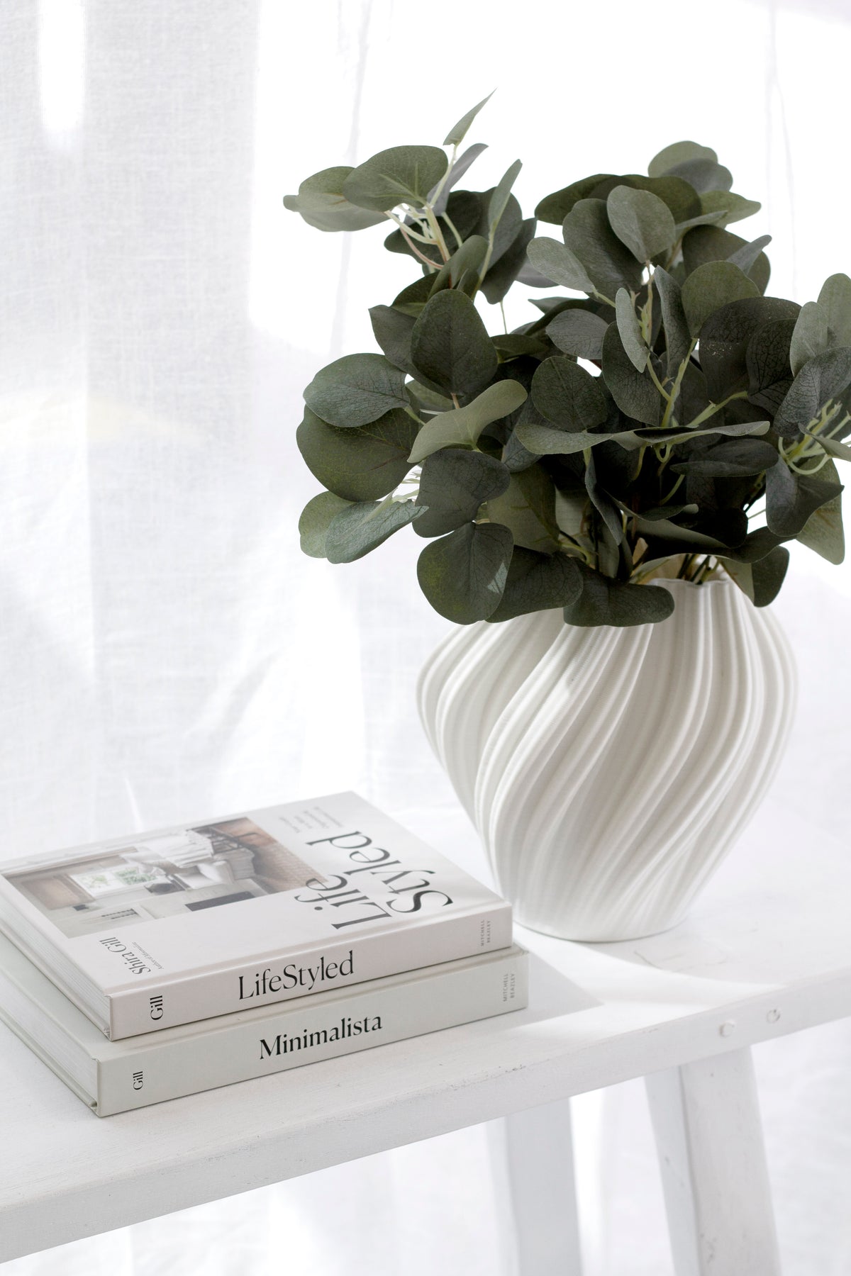 LifeStyled book by Shira Gill styled with greenery and Minimalista book, inspiring guide to minimalism and intentional living.
