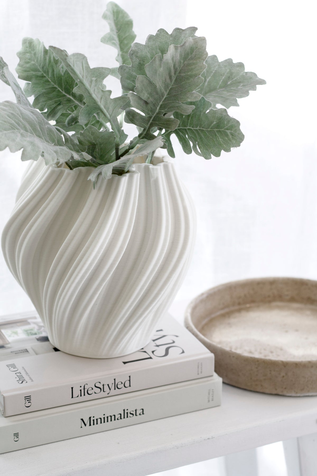 LifeStyled by Shira Gill stacked with Minimalista beside white sculptural vase and neutral tray in minimalist interior