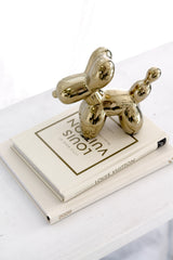 Little Book of Louis Vuitton styled with a gold balloon dog sculpture – chic coffee table book decor for luxury interiors.