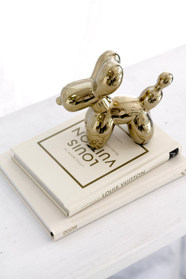 Little Book of Louis Vuitton styled with a gold balloon dog sculpture – chic coffee table book decor for luxury interiors.