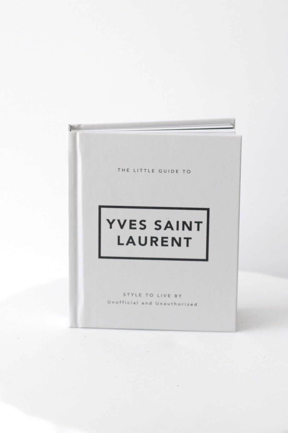 Little Guide to Yves Saint Laurent fashion book in white cover, minimalist coffee table styling