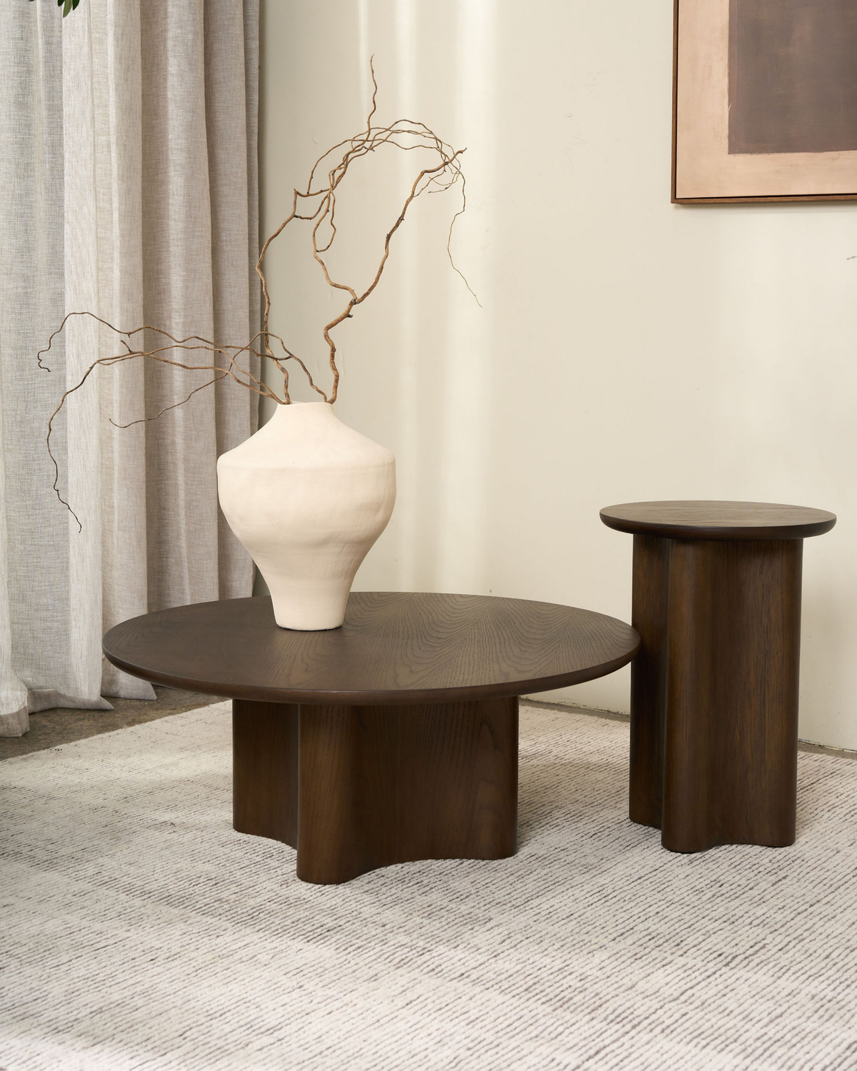 Brown Oak Luma Coffee Table with a cream vase of twisted branches beside the taller Luma Side Table