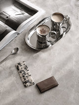 Luxury black and white acetate comb styled on a marble vanity with silver coffee tray and interior book.